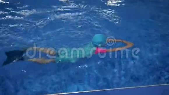 小女孩正在学习游泳在游泳池潜水和漂浮在水中视频的预览图