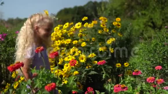 小天使女孩带着花头走在五颜六色的花朵之间视频的预览图