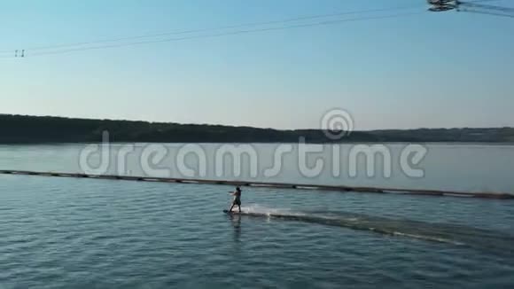 女孩守夜人骑着湖水湖中索道的航拍镜头视频的预览图