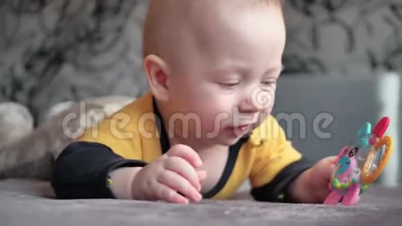 可爱的5个月大的男孩玩着一个出牙玩具视频的预览图