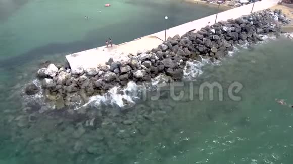 夏季令人叹为观止的绿松石海的空中景色码头和岩石在AgiaParaskeviH地区出现了水视频的预览图