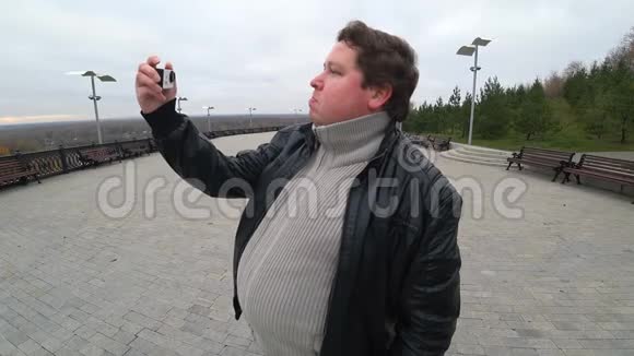 人用一个动作摄像机射击自己一个胖子在拍摄自己的动作镜头视频的预览图