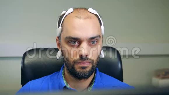 一名男子头戴生物信号脑电图耳机视频的预览图