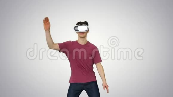 休闲男子在VR眼镜跳舞玩电子游戏初学者水平梯度背景视频的预览图