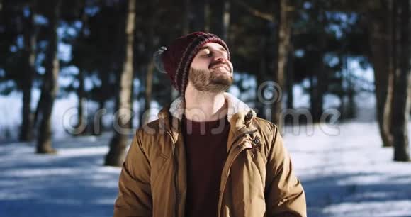 在森林冬天的时候他在镜头前呼吸新鲜空气他笑得大大的感到兴奋视频的预览图