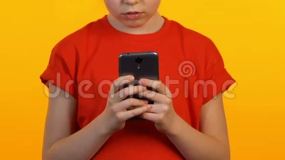 小女孩在智能手机上玩游戏或在线聊天新的信使应用程序视频的预览图