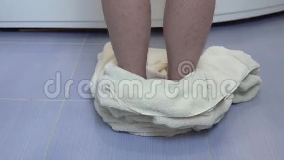 一个男人把浴巾扔到地板上爬进浴室腿的后视图视频的预览图