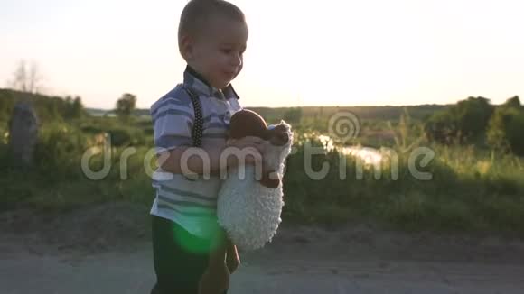一个小男孩抱着一只柔软的玩具羊高兴地跟她一起慢悠悠地跑着视频的预览图