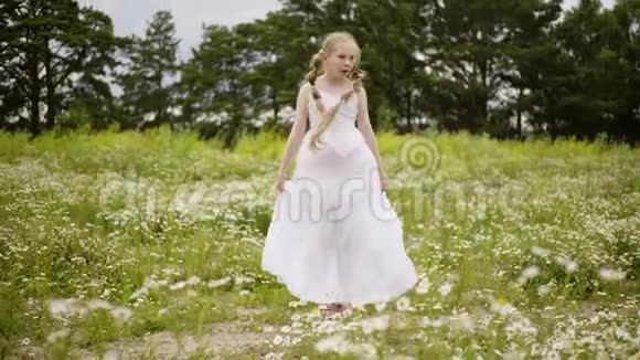 夏天带发辫的少女在绿色草地上跳跃穿着白色裙子的浪漫少女视频的预览图