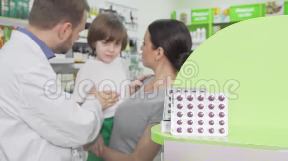 药剂师给一个小男孩和他的母亲注射了带有药丸的水泡视频的预览图