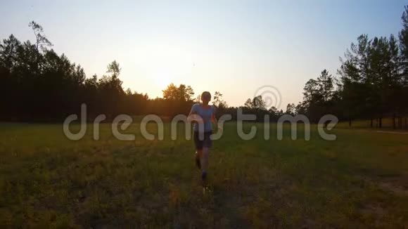 日落时分在草地上奔跑的女孩视频的预览图