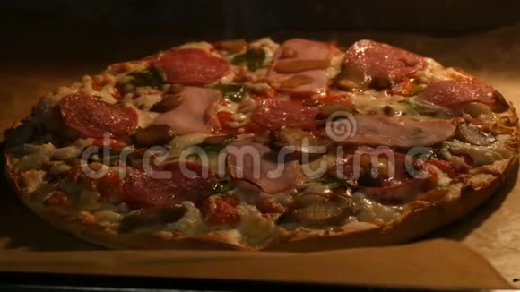 带有蘑菇意大利腊肠培根草药和奶酪的美味比萨饼是在烤箱里煮的视频的预览图
