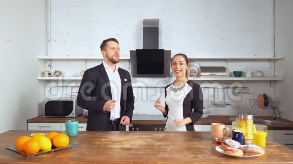 年轻快乐的夫妻在家厨房跳舞视频的预览图