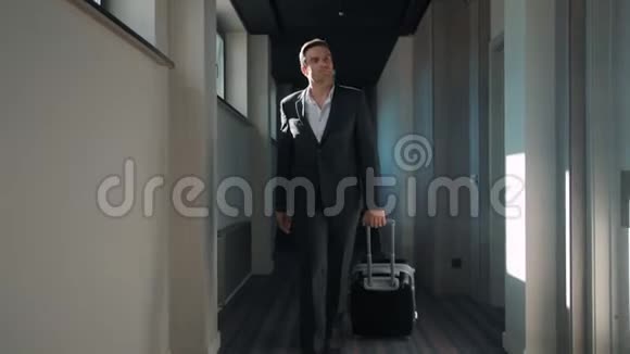 商人在酒店走廊散步商务旅客抵达商务酒店视频的预览图