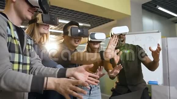 使用虚拟现实眼镜玩得开心的多民族嬉皮士群体视频的预览图