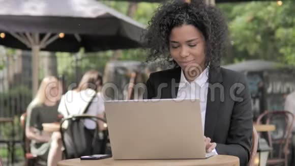 非洲女商人因户外咖啡厅笔记本电脑的结果而震惊视频的预览图