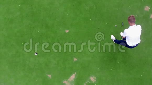 在球场上打高尔夫球的人的俯视图视频的预览图