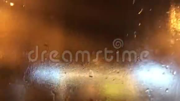 夜晚城市灯光透过潮湿的车窗视频的预览图