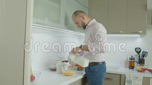 男人用电动搅拌器搅拌鸡蛋和牛奶视频的预览图
