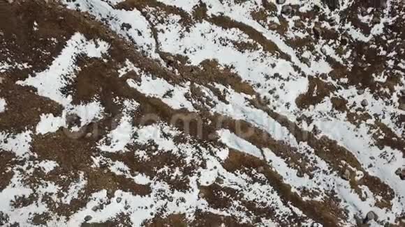 一个快速下降的无人机观雪地浮雕地黄草石视频的预览图