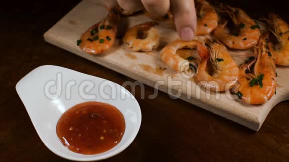 用手将虾蘸海鲜酱收起来泰国热辣食物视频的预览图