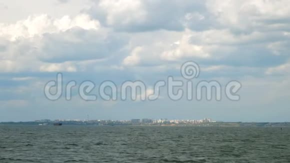 用汹涌的黑海远处有城市建筑的海岸线和美丽的天空视频的预览图