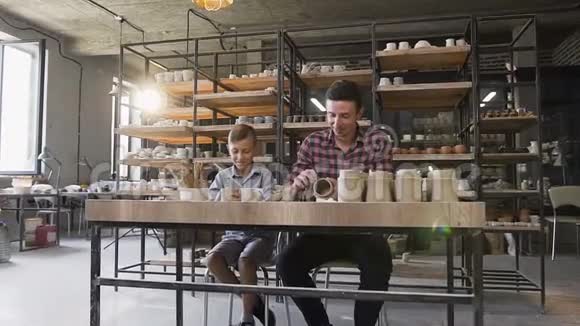 白人可爱的父亲和小儿子在花瓶上做图案视频的预览图