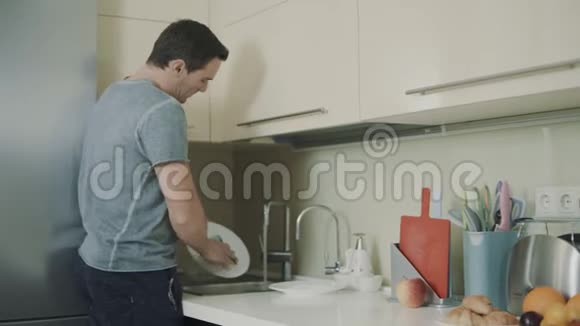 丈夫晚饭后做家务男人用海绵洗碗视频的预览图