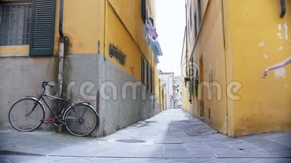 两个年轻的旅行妇女在黄色的墙壁上快乐地散步和跳跃视频的预览图