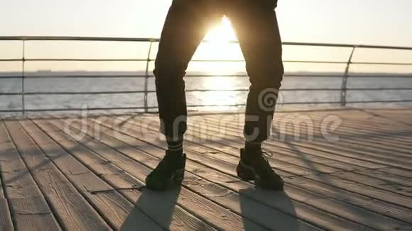 一个年轻的时尚的男舞者表演自由式的嘻哈舞现代舞蹈站在阳光下视频的预览图