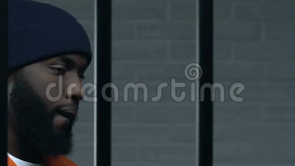 一名黑人罪犯积极地关押监狱看着摄像机有罪视频的预览图