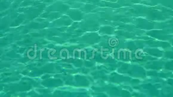 摘要绿松石背景清水在慢运动中循环涟漪和波浪折射阳光顶部视图视频的预览图
