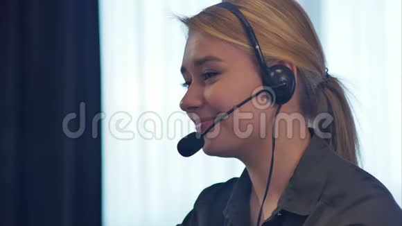 女性客户支持操作员带耳机交谈和微笑视频的预览图