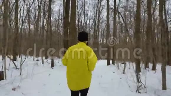 冬季森林雪道上运动员的后景视频的预览图