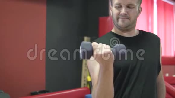 人在健身房里用哑铃摇动肌肉视频的预览图
