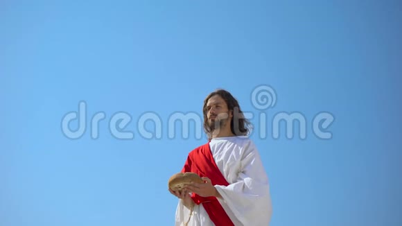 耶稣上帝举起手中的面包祝福圣餐圣餐视频的预览图