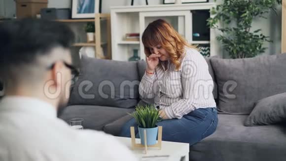 超重的年轻女性在与办公室心理学家交谈时哭泣视频的预览图