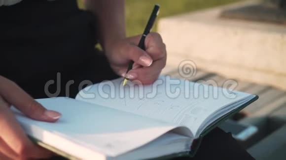 商业女性工作在笔记本上做笔记女人用手写字重点写在笔记本上视频的预览图