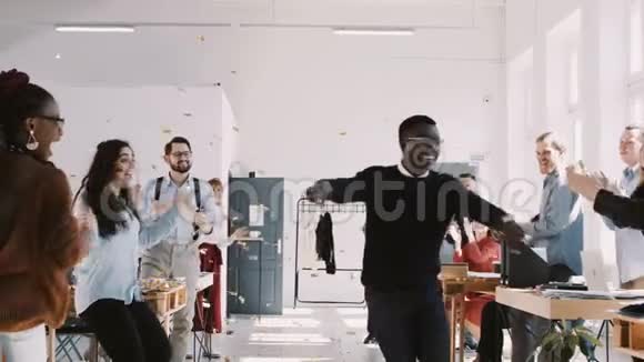红色EPIC快乐年轻的黑人商人跳舞与纸屑庆祝成功与团队在办公室聚会慢动作视频的预览图