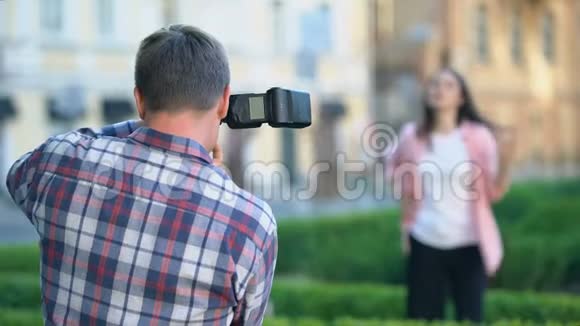 女模特向男摄影师拍照夏季公园拍照视频的预览图