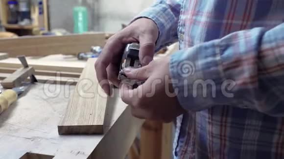 工人用卷尺测量木板木匠用金属胶带测量木板的长度视频的预览图