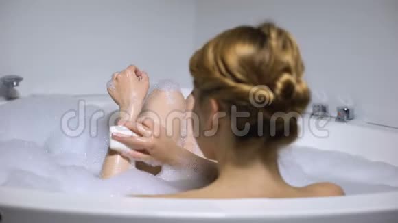 女性沐浴用清洁肥皂清洗身体美容程序后视视频的预览图
