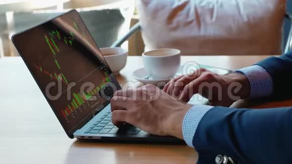 一个商人在咖啡馆里用笔记本电脑工作喝咖啡休息用电脑键盘打字还有一个时间表视频的预览图