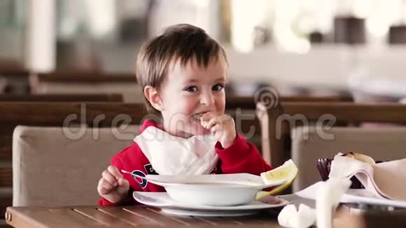 小男孩在餐桌上吃汤和面包视频的预览图