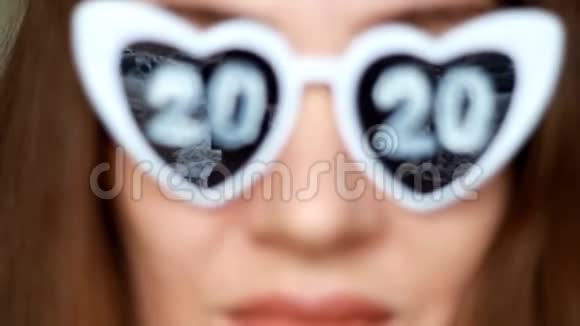 特写一个戴太阳镜的女人的肖像数字2020新年圣诞节女孩微笑着看着镜头视频的预览图