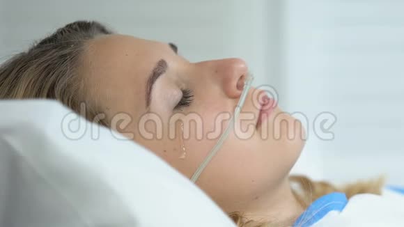 伤心哭泣的女人鼻管躺在病床上疾病绝望视频的预览图