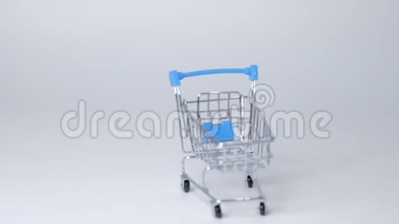 白色背景上的购物玩具手推车有一些复制空间网上购物概念特写慢动作视频的预览图