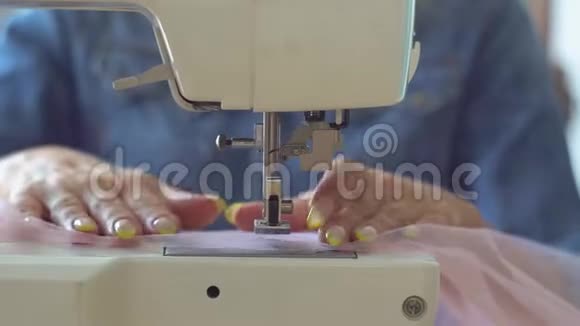 缝纫室里漂亮的女裁缝金发在缝纫机上缝制织物手和缝纫针的特写镜头视频的预览图