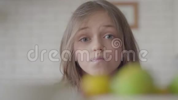 可爱的情绪化的小女孩在镜头里做鬼脸的肖像有趣的孩子用手摸她的脸视频的预览图