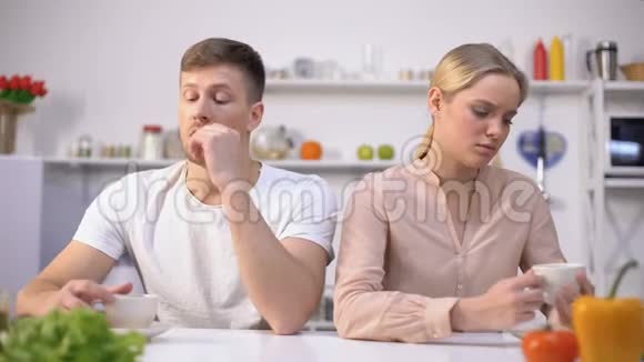 一对年轻夫妇争吵后默默地坐在厨房里关系危机视频的预览图